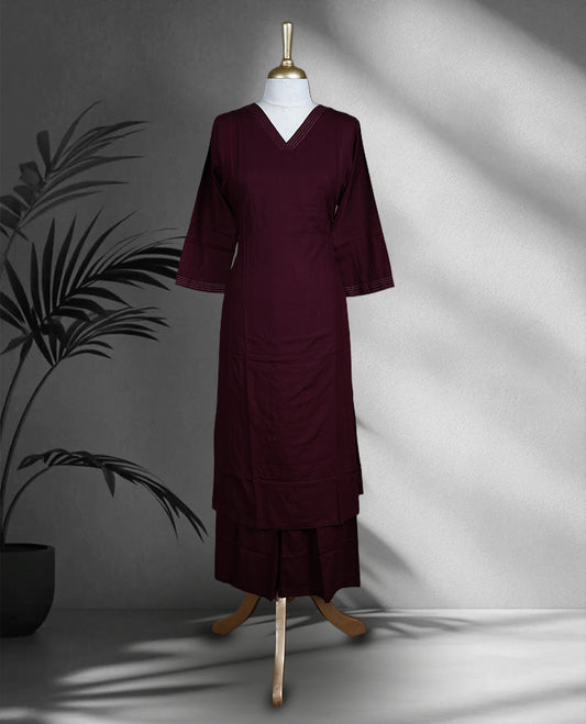 Dark grape colored cord set featuring a plain V neck kurta with subtle stitch detailing on neckline and sleeves, paired with matching palazzo.