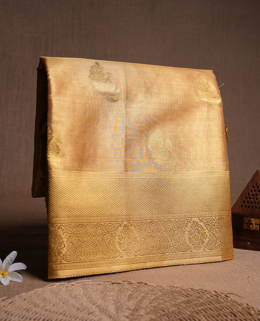 Gold colour tissue banaras silk saree featuring antique gold peacock zari motifs on the body with rich traditional zari border and pallu, paired with a matching blouse piece.