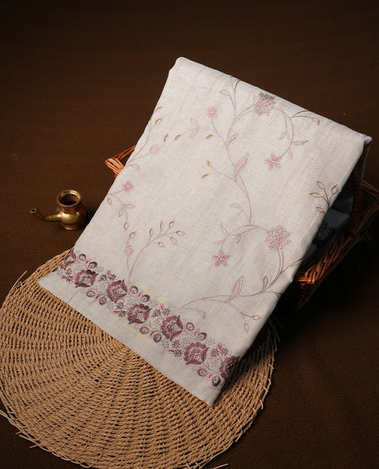 Cream colour semi tusser silk saree featuring with brown colour thread embroidery kodi pattern all over body, pallu, border  and paired with matching blouse piece.