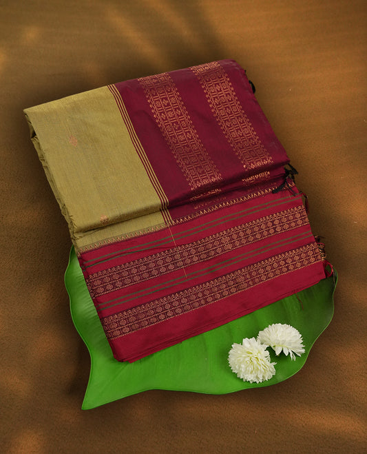 Deep mustard yellow Kalayani cotton saree with delicate woven motifs on the body, enhanced by a rich maroon zari border and pallu with traditional patterns, paired with a matching blouse piece.