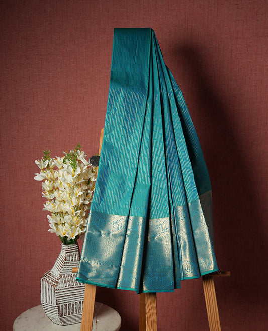 Double shade blue colour Semi Silk Saree with a gold dotted striped body and a self coloured traditional border, paired with a contrasting purple pallu and a matching blouse piece