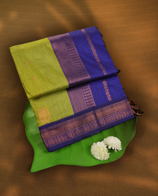 Lemon green colour Kalyani cotton saree with contrast royal blue border adorned with intricate copper zari weaving & Paired with matching blouse.