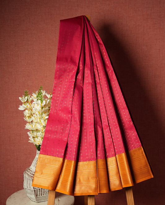 Rani pink colour Semi Silk Saree with gold zari striped patterns on the body, paired with a contrasting mustard traditional pallu and border, and a matching blouse piece.