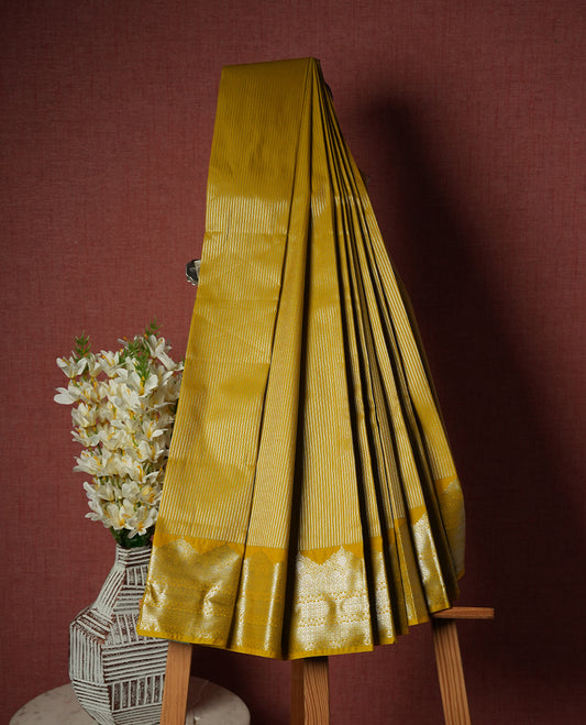 Olive yellow colour Semi Silk Saree with silver zari patterns on the body with self coloured border, paired with a contrasting Dark violet colour traditional pallu, and a matching blouse piece.