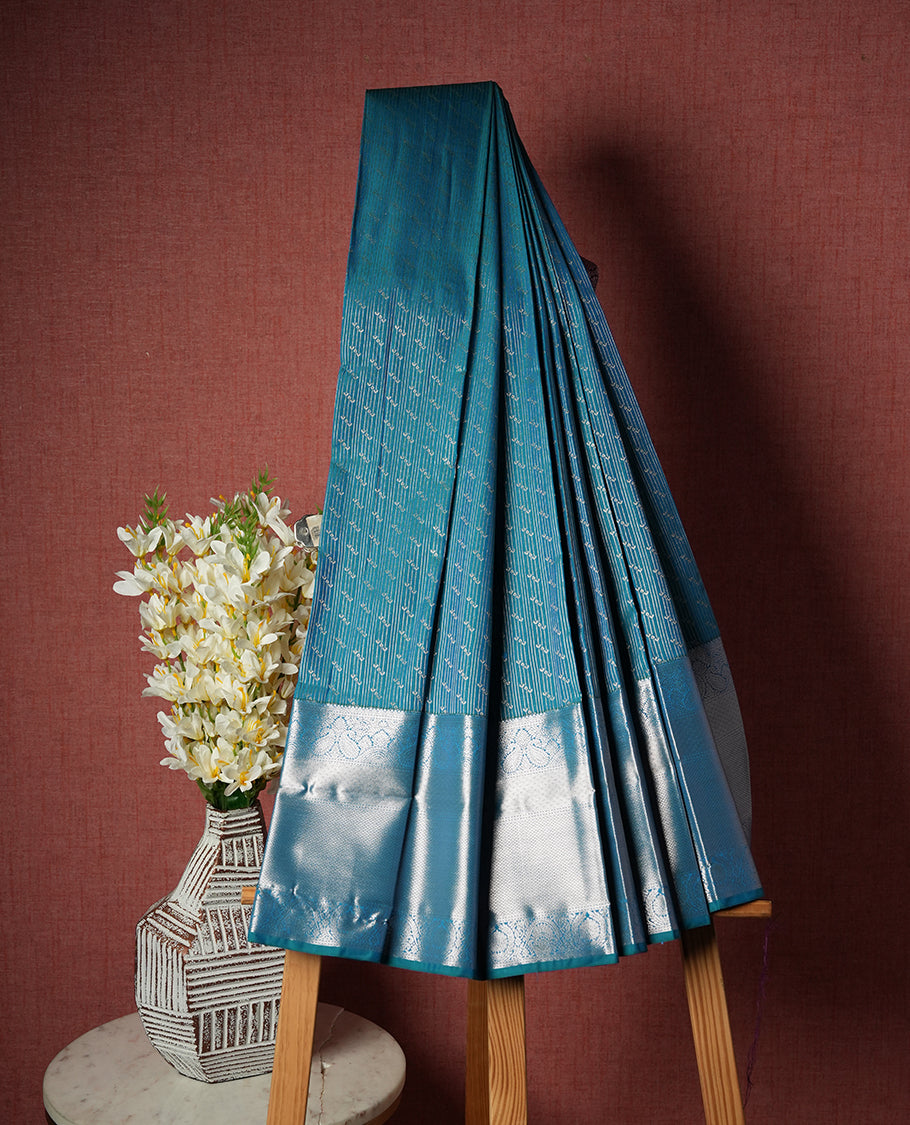 Teal Blue Colour Semi Silk Saree with Silver Diagonal Striped Butta Body, Self Coloured Silver Zari Pallu & Border, Paisley Motifs, and Matching Blouse Piece