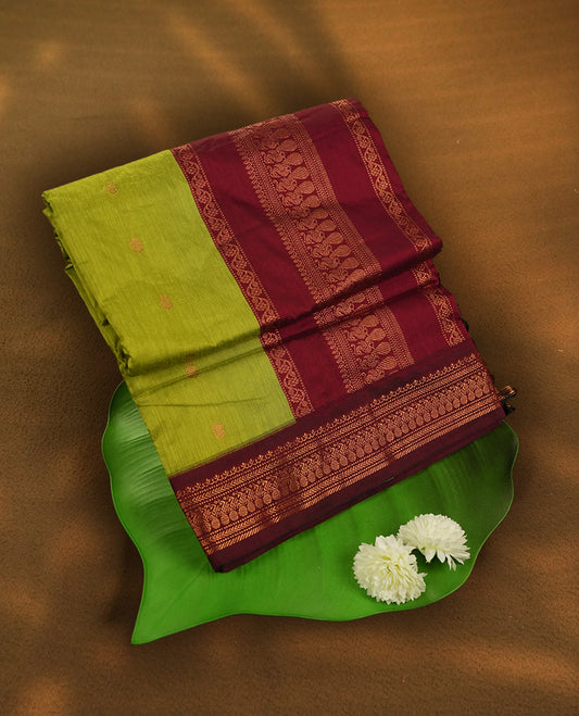 Lemon green colour Kalyani Cotton saree with rich maroon border and pallu, featuring copper zari motifs, small floral motifs on the body, and intricate weaving & includes a matching blouse piece.