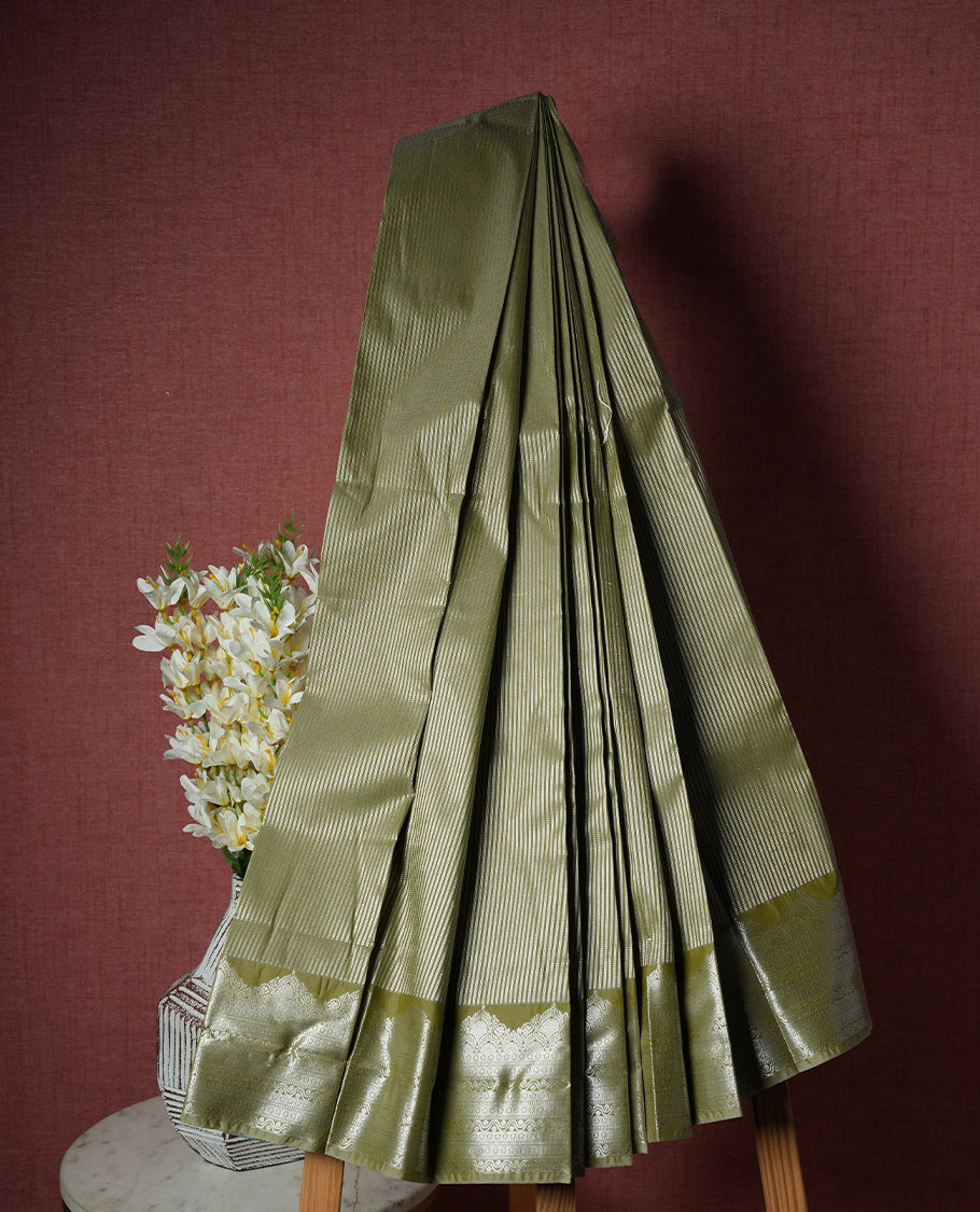 Dark khaki colour Semi Silk Saree with silver zari patterns on the body with self coloured, paired with a contrasting dark violet colour traditional pallu and a matching blouse piece.