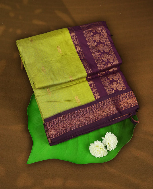 Lemon green colour Kalyani Cotton saree with delicate woven zari golden motifs all over, paired with a contrasting wine border and pallu intricately woven with rich zari & Comes with a matching blouse piece.