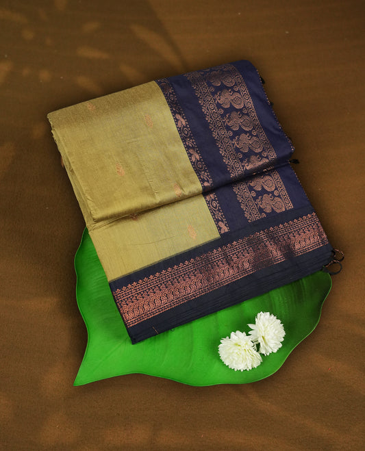 Sand colour Kalyani Cotton saree with subtle zari woven motifs all over, paired with a contrasting deep navy blue rich copper zari border and pallu & Comes with a matching blouse piece.