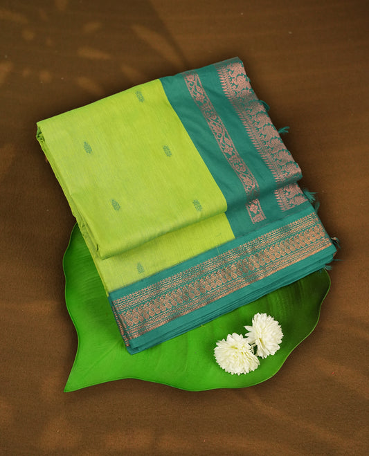 Lemon green colour Kalyani Cotton saree with delicate woven zari motifs all over, paired with a contrasting green border and pallu intricately woven with rich copper zari & Comes with a matching blouse piece.
