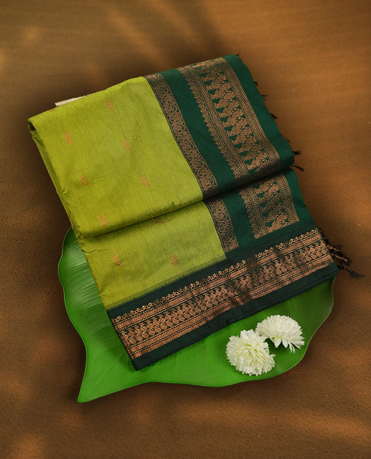 Lemon green colour Kalyani Cotton saree with rich green colour border with peacock motifs on  pallu, featuring copper zari and intricate weaving & Includes a matching blouse piece.