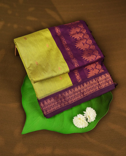 Lemon green colour Kalyani Cotton saree with delicate woven zari motifs all over, paired with a contrasting wine border and pallu intricately woven with rich copper zari & Comes with a matching blouse piece.