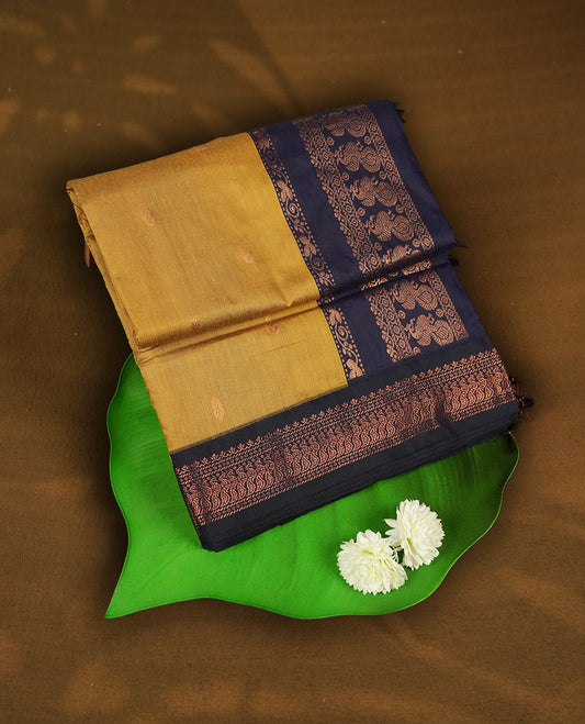 Golden yellow colour Kalyani cotton saree with intricate small motifs all over, paired with a contrasting navy blue  rich zari woven border and pallu & Comes with a matching blouse piece.