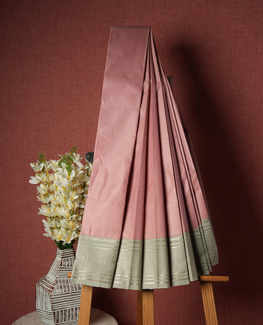 Pastel pink colour Semi Silk Saree with gold zari striped patterns on the body, paired with a contrasting Gray colour traditional pallu and border, and a matching blouse piece.