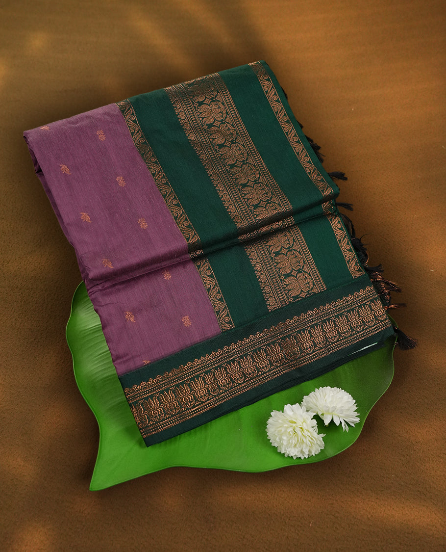 Lavender colour Kalyani Cotton saree with deep green border and pallu, adorned with copper zari lotus motifs and intricate weaving & Comes with a matching blouse piece.
