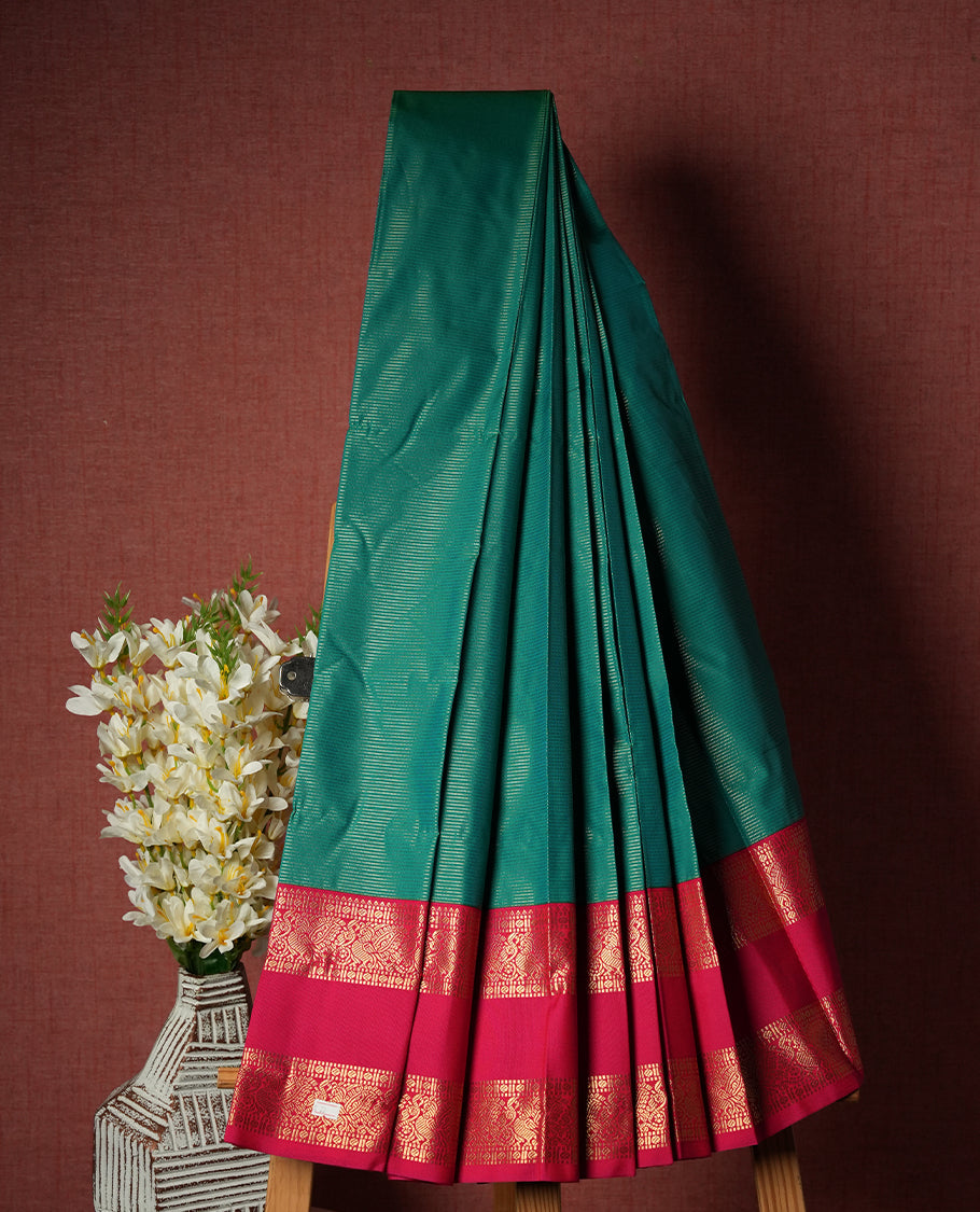 Teal Green Colour Semi Silk Saree with Self Textured Striped Body, Contrasting Coral Pink Golden Zari Pallu & Border, Traditional Paisley Motifs, and Matching Blouse Piece