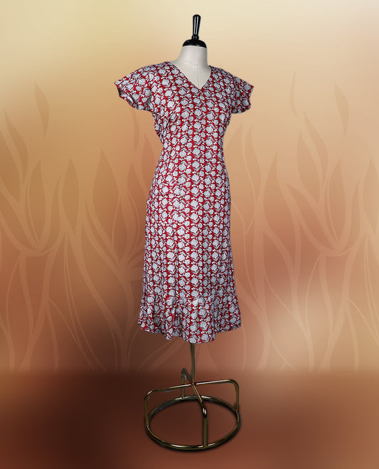 Red colour nightwear with a charming white floral print, featuring a V neckline, flutter sleeves, and a flared ruffle hem, A perfect pick for casual days, summer outings, or light festive wear.