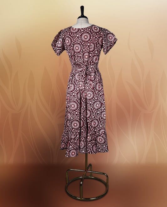 Dark maroon colour nightwear with intricate floral prints in circular patterns in beige colour, Designed with a V neckline, short sleeves, and a flared hemline. Ideal for casual outings, workwear, or ethnic inspired looks.