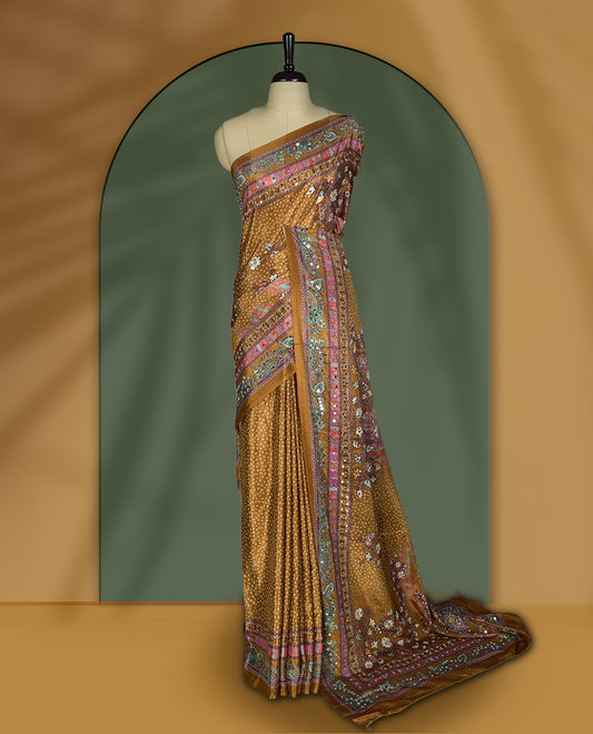 Mustard brown colour saree with intricate multicolor floral and paisley patterns, highlighted by vibrant borders & Paired with a matching blouse.