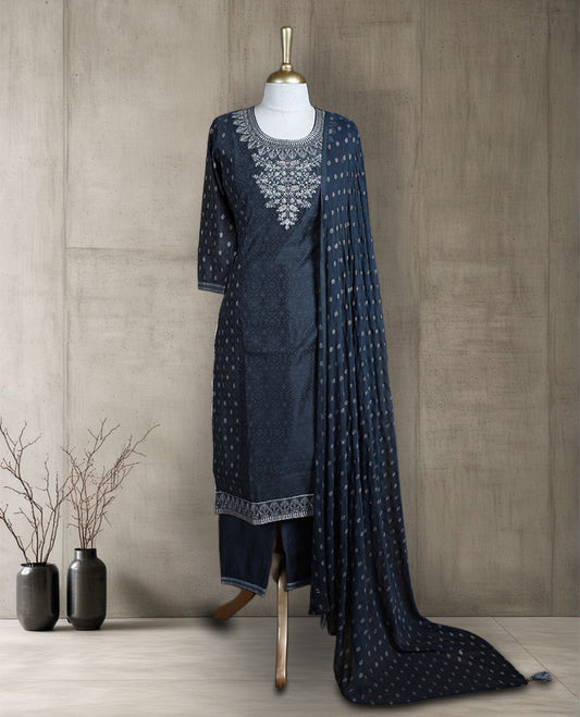 Dark grey colour salwar from TWARA, featuring a delicate silver embroidered neck with floral thread work, all over silver style embroidery on the top, paired with a matching bottom and an elegant dupatta.