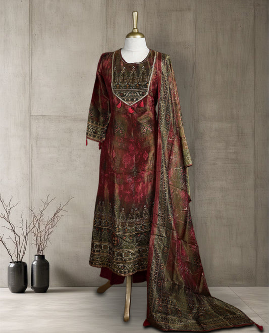 Maroon and olive green salwar from TWARA, featuring a round neck with intricate zari embroidery and tassel detailing, paired with a matching bottom and a richly woven dupatta showcasing traditional motifs.