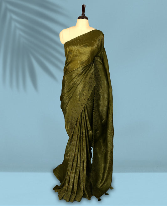 Olive Colour crush soft silk saree boasts a lustrous crinkled texture with subtle self colored floral Motifs on the body and an elegant Floral thread cutwork border, paired with a matching blouse.