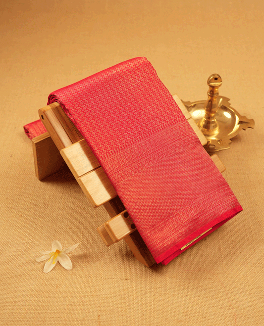 Red Colour Manthrakodi saree featuring a golden zari brocade body, complemented by a self coloured zigzag brocade border and a matching blouse.