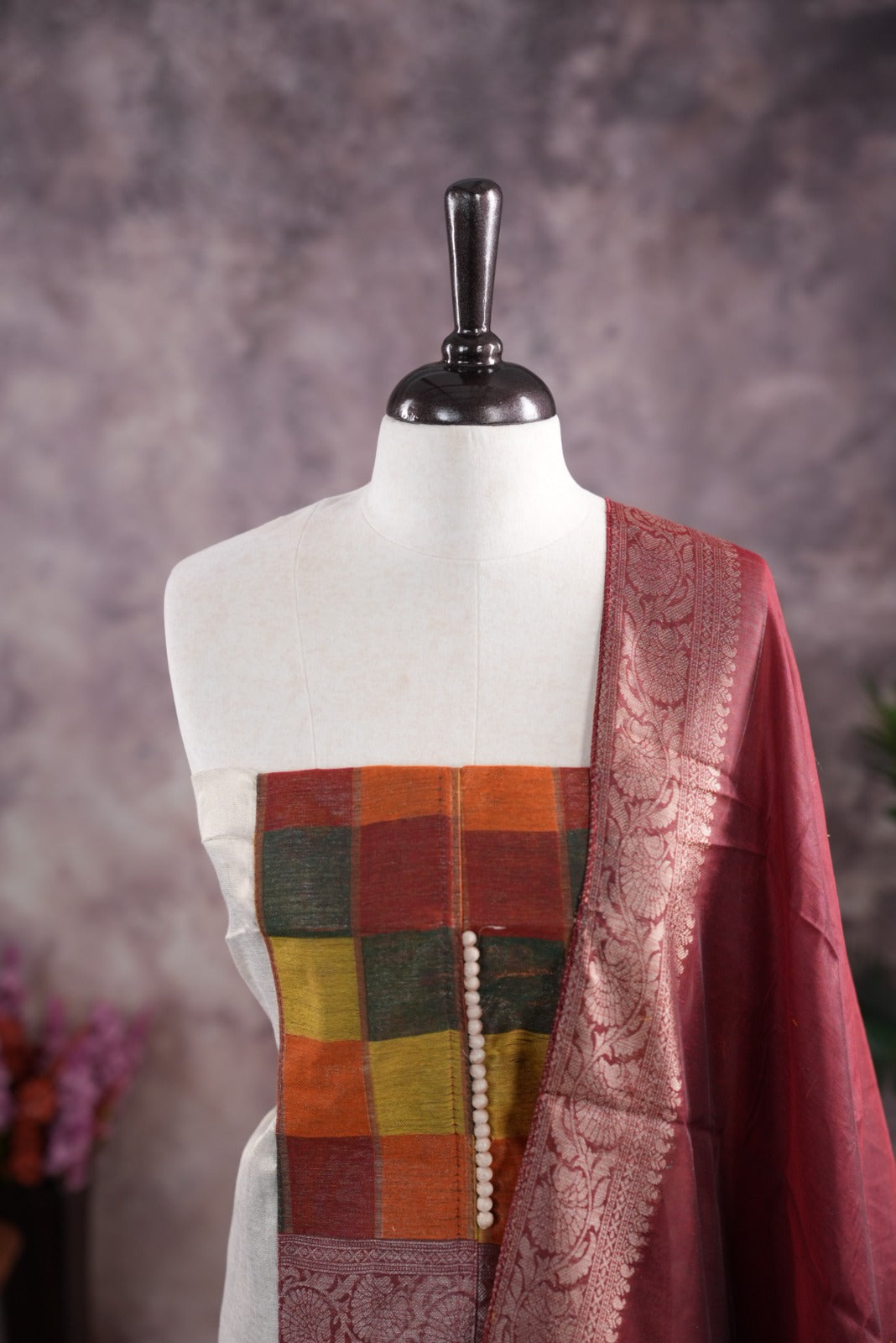 Maroon colour tissue Madras check salwar material featuring a plain body with a classic Kasavu border, paired with a Chanderi dupatta adorned with a matching Kasavu border and a Shantoon fabric bottom.