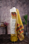 Yellow colour tissue Madras check salwar material featuring a plain body with a classic Kasavu border, paired with a Chanderi dupatta adorned with a matching Kasavu border and a Shantoon fabric bottom.