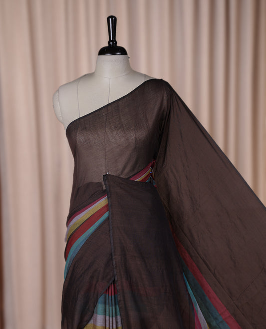 Brown colour soft cotton saree with rainbow colored horizontal lines on the body, a vibrant multicolor pallu, and a subtle border & Elegant and lightweight, this saree comes without a blouse piece for a customizable style.