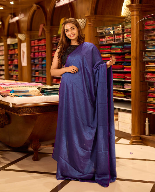 Double shade Purple colour viscose saree in rich teal shade featuring a subtle sheen and lightweight drape, enhanced with satin piping finished border, paired with a matching blouse piece