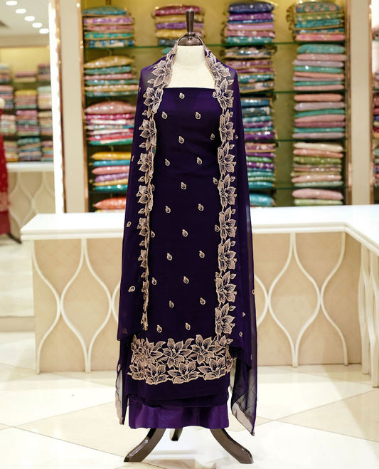 Deep purple colour georgette salwar set featuring gold zari buttas on body, floral embroidery and scalp work on dupatta, paired with matching bottom.