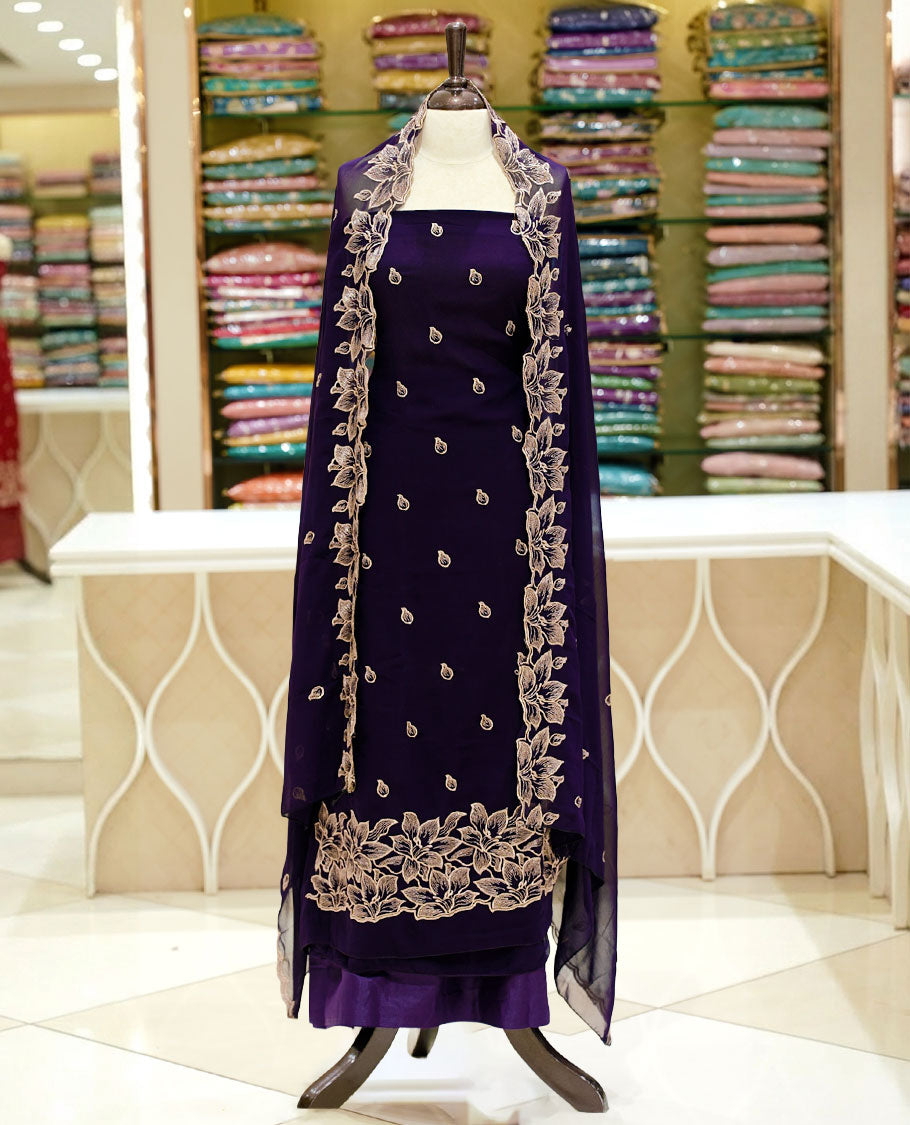 Deep purple colour georgette salwar set featuring gold zari buttas on body, floral embroidery and scalp work on dupatta, paired with matching bottom.