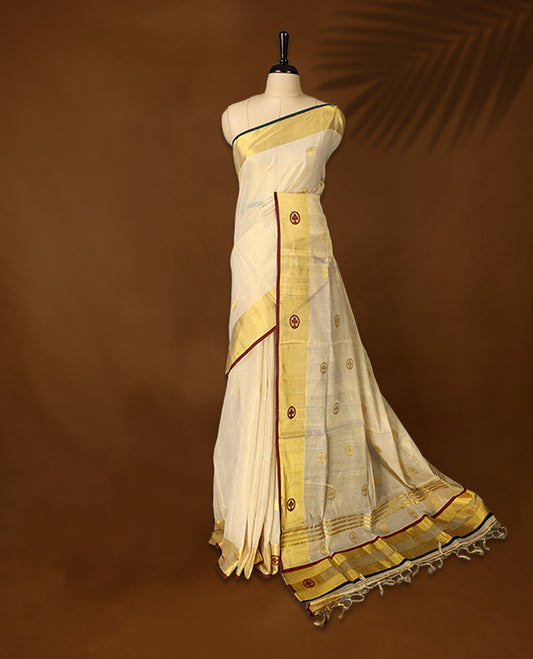 Elegant handloom soft tissue kerala saree. Featuring a cream base with gold zari, maroon , green borders & woven motifs, and paired with a matching blouse, perfect for festivities