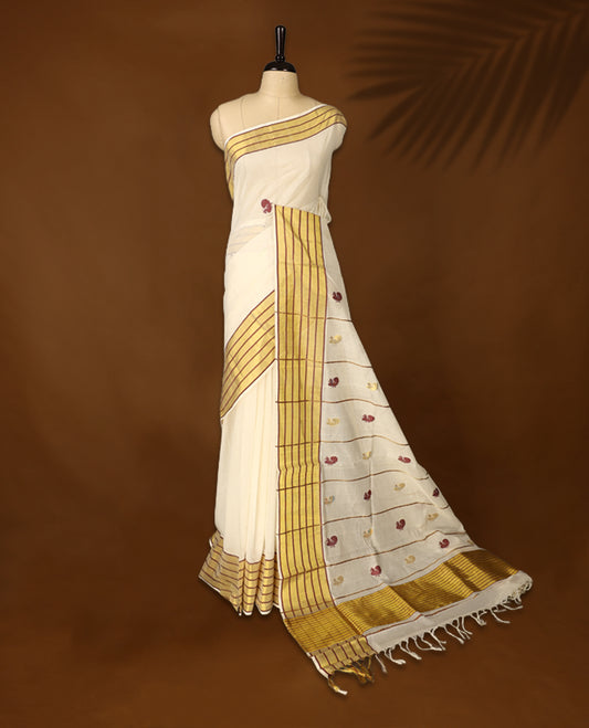 Elegant pure handloom cotton Kerala saree with a cream base, gold zari stripes, maroon & gold floral motifs. Paired with a matching blouse, it’s perfect for festive celebrations and traditional occasions.