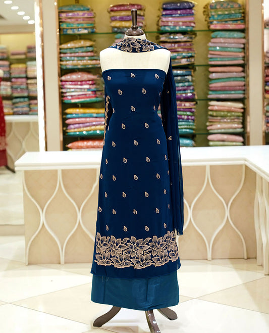 Navy blue colour georgette salwar set featuring gold zari buttas on body, floral embroidery and scalp work on dupatta, paired with matching bottom.