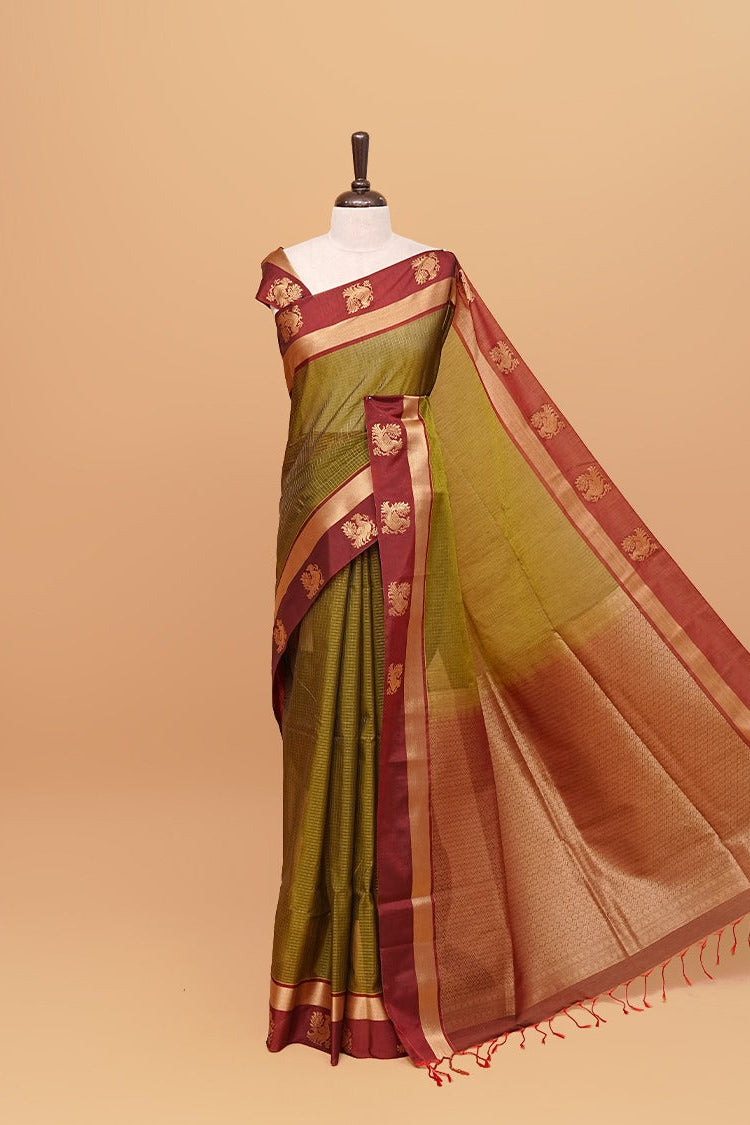 Olive Green colour silk cotton saree featuring  copper zari Check motifs on body ,contrast maroon with copper zari motifs on border & pallu, comes with matching blouse piece