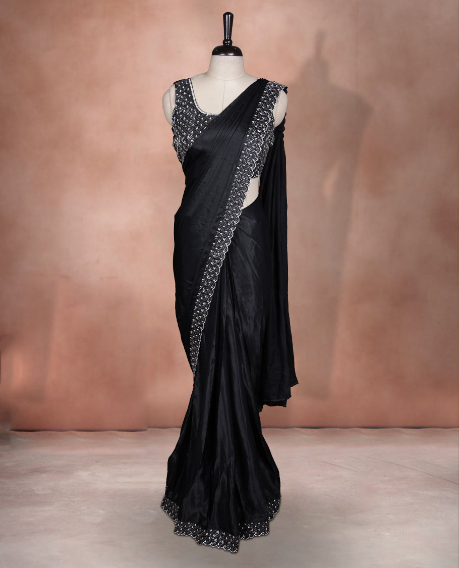 Elegant Black colour ready to wear saree adorned with rich white stone embroidery along the border and pallu, paired with a heavily embellished matching blouse for a grand festive look.