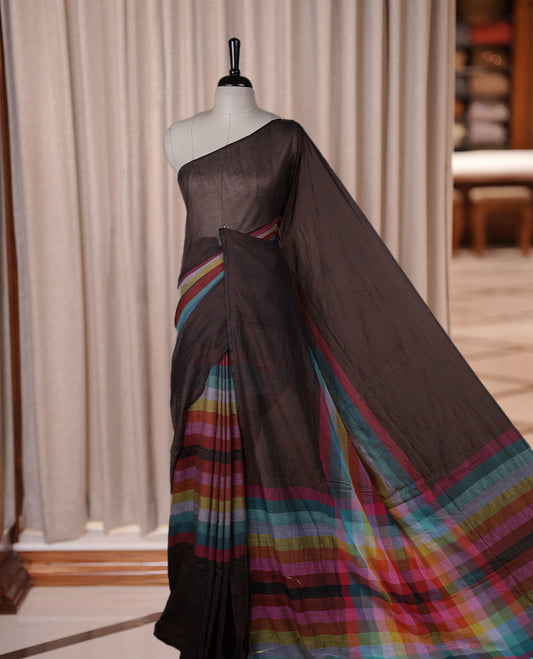 Brown colour soft cotton saree with rainbow colored horizontal lines on the body, a vibrant multicolor pallu, and a subtle border & Elegant and lightweight, this saree comes without a blouse piece for a customizable style.