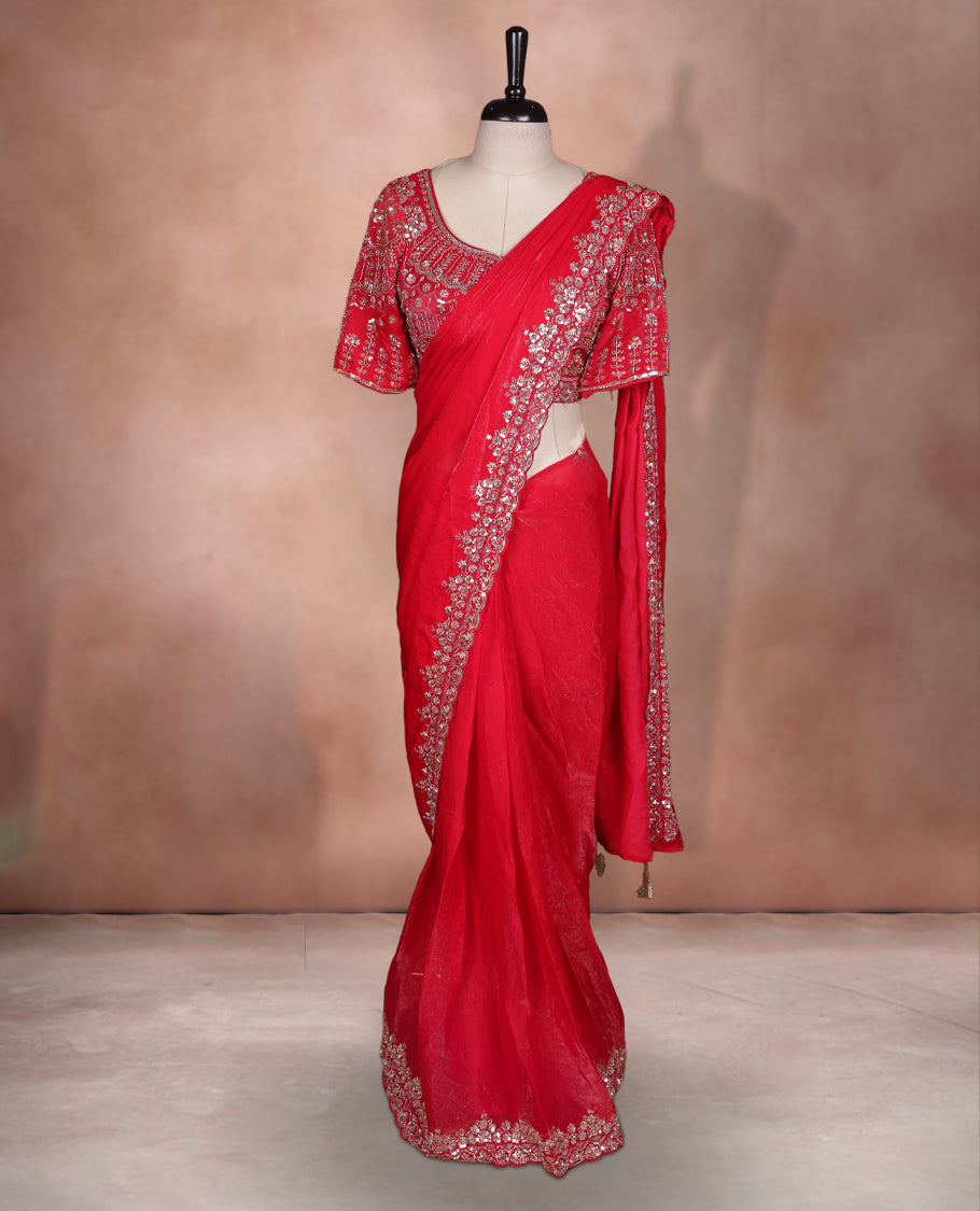 Elegant Red colour ready to wear saree adorned with rich Gold bead embroidery along the border and pallu, paired with a heavily embellished matching blouse for a grand festive look.