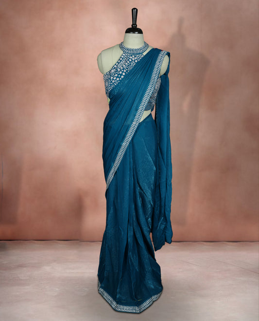 Elegant Aqua blue colour ready to wear saree adorned with rich white stone embroidery along the border and pallu, paired with a heavily embellished matching blouse for a grand festive look.