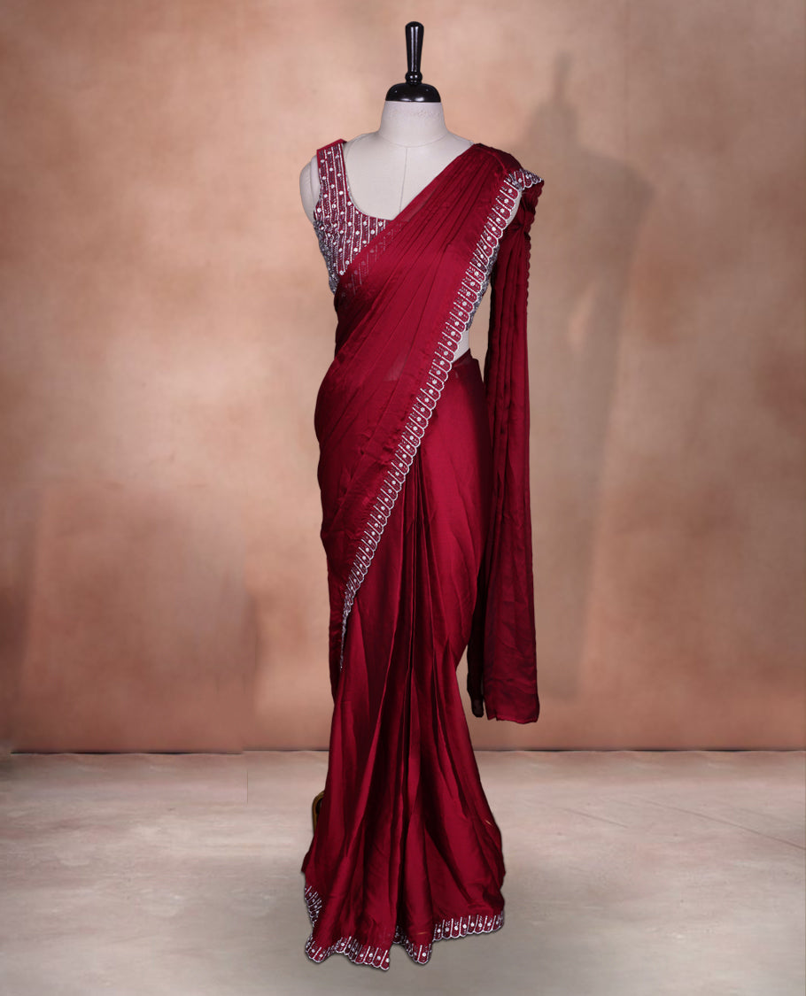 Elegant Dark red colour ready to wear saree adorned with rich White stone and bead embroidery along the border and pallu, paired with a heavily embellished matching blouse for a grand festive look.