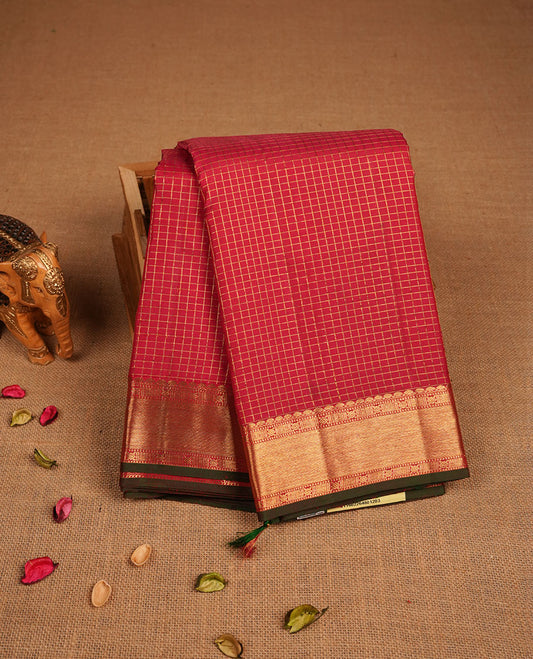 Red colour pure traditional Kancheepuram silk saree adorned with gold zari Checks across the body, featuring elegant traditional borders, beautifully paired with a matching blouse piece.