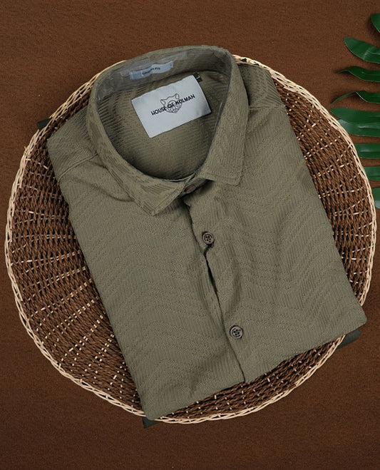 Pastel olive green colour textured shirt featuring a subtle chevron pattern, classic collar, and short sleeves & Crafted for effortless comfort and style.