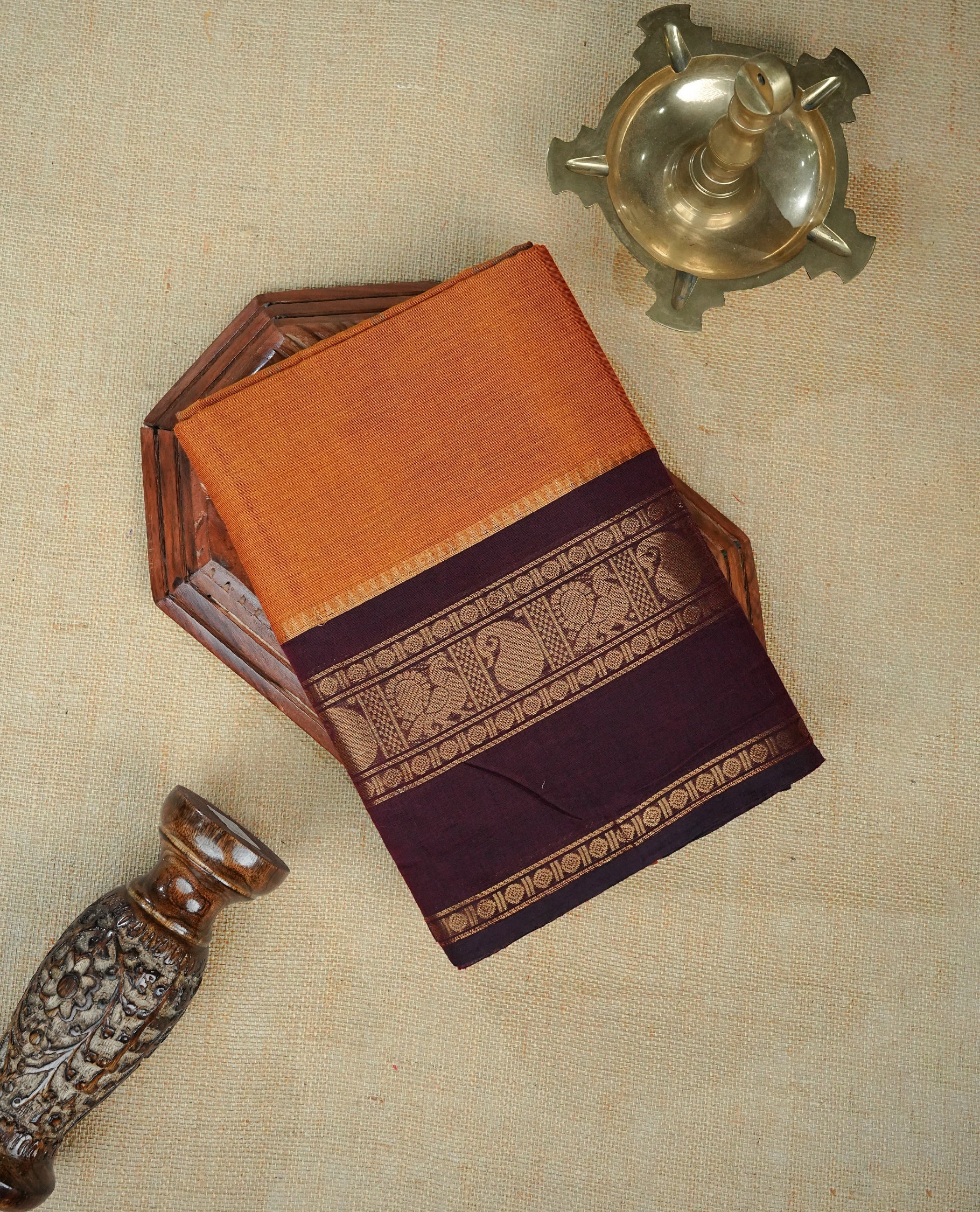 Mustard Orange Colour Chettinad Cotton Saree Featuring a Plain Body ,complemented by Contrast Maroon Colour With Gold Zari border, paired with matching blouse piece.