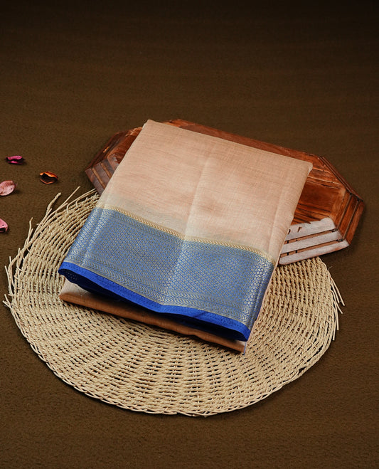 Light Gold Tussar saree featuring Gold zari buttas on body, complemented by contrast Blue Colour with Gold zari border, comes with matching blouse piece.