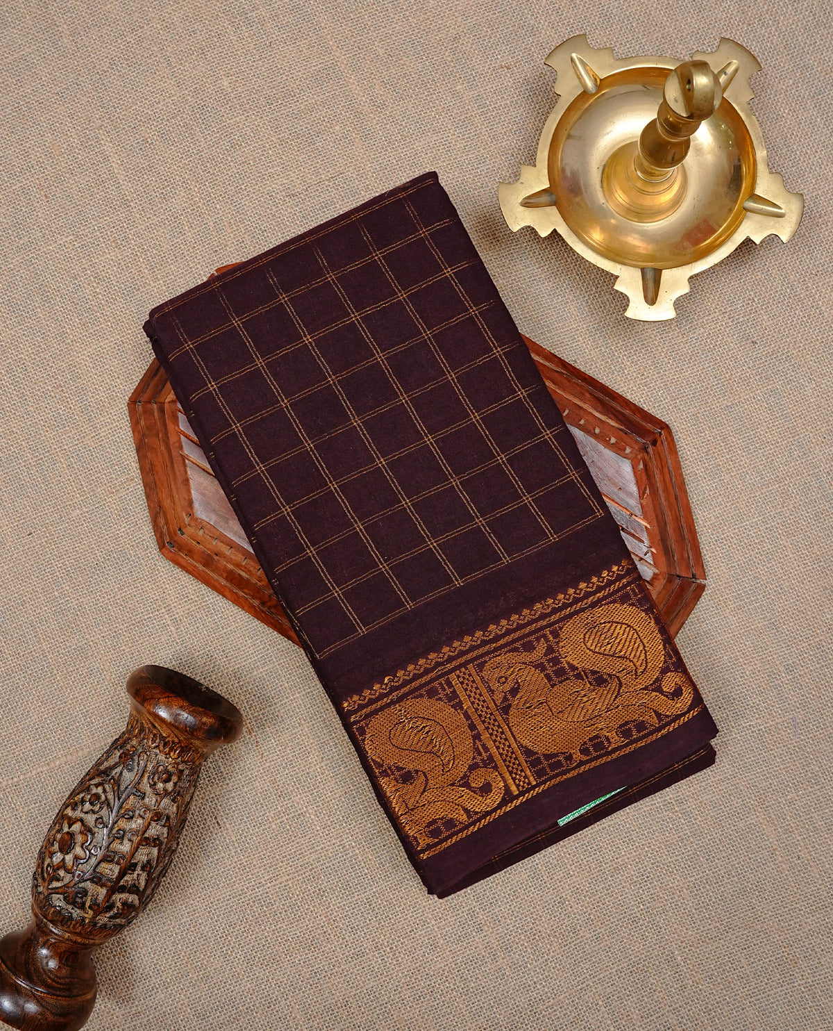 Chocolate brown Colour Sungudi Cotton saree featuring elegant gold zari checks on  Body , complemented by a classic Gold zari peacock motifs on border and matching pallu, paired with a contrast pink blouse piece.