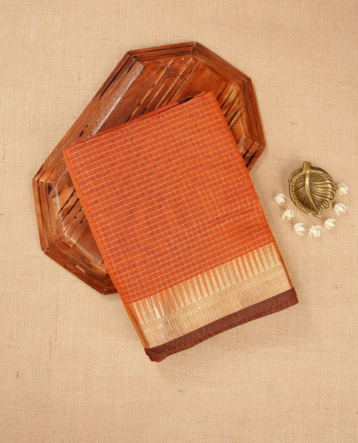 Rust orange colour Maheshwari cotton saree, gold zari small checks on body, complement self colour gold zari temple design border comes with matching blouse.