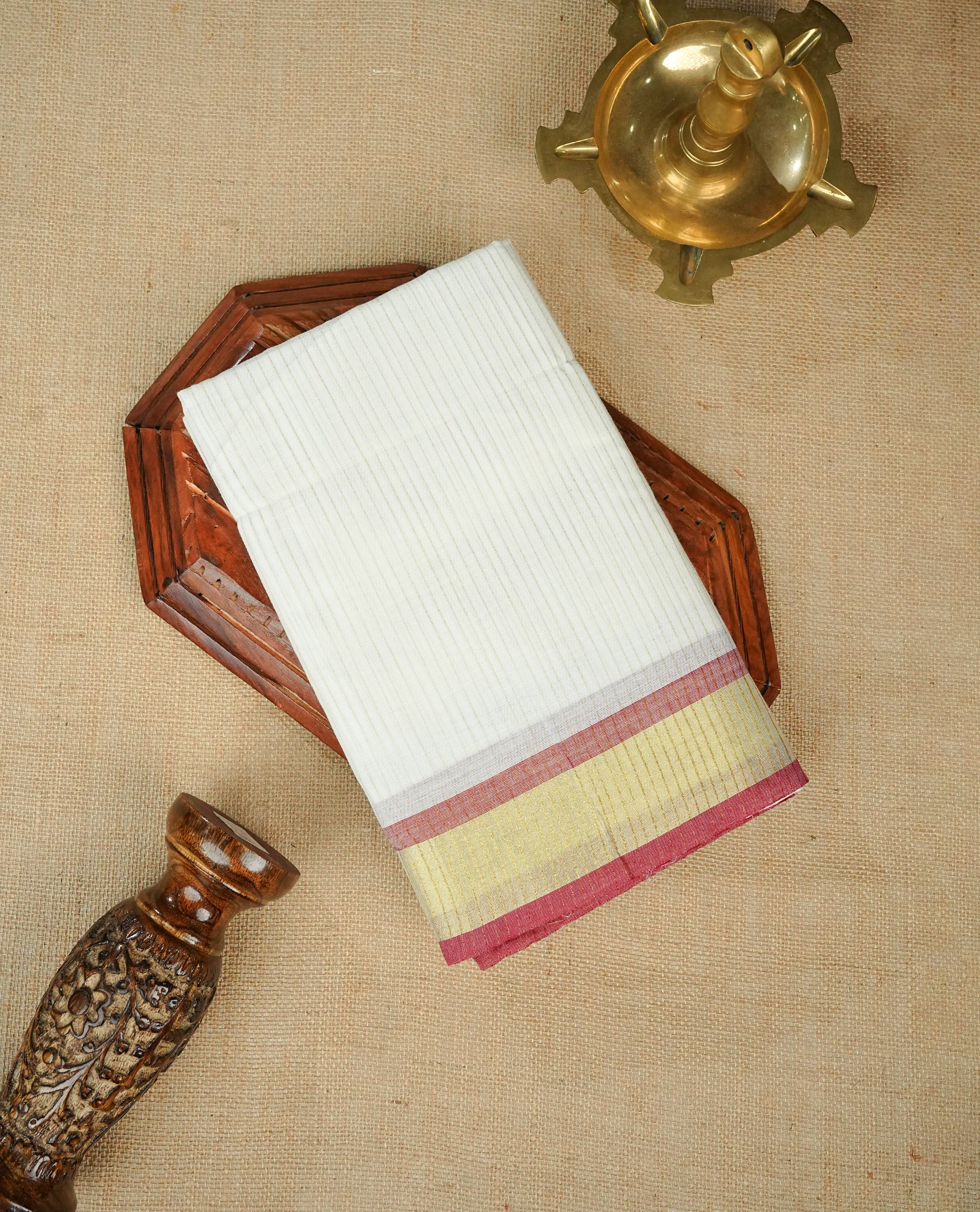 White colour chettinad cotton saree Featuring Gold zari Strips on body, complemented by contrast Maroon colour with zari border, comes with matching blouse piece.