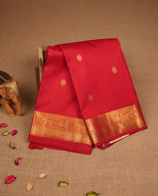 Red colour pure traditional Kancheepuram silk saree adorned with an elegant zari motif on the body